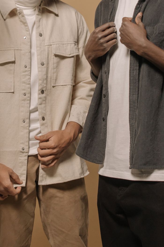 Stylish men's casual fashion featuring layered outfits with beige and gray tones.